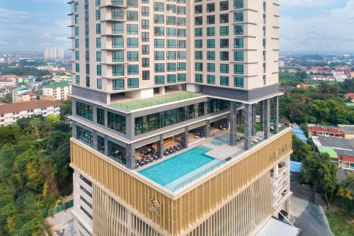 an aerial view of a tall building with a swimming pool at Brighton Grand Hotel Pattaya - SHA Extra Plus in North Pattaya