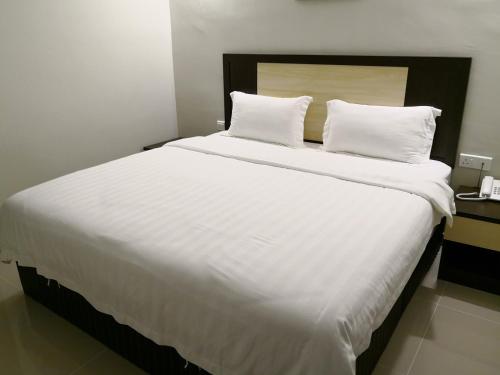 Ένα ή περισσότερα κρεβάτια σε δωμάτιο στο The One Boutique Hotel