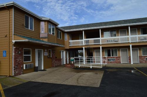 a building with a parking lot in front of it at Western Motel in Junction City