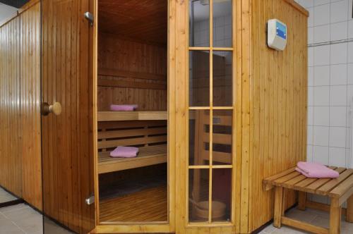 a wooden sauna with pink towels in it at Landhaus Dürkop in Wolfenbüttel