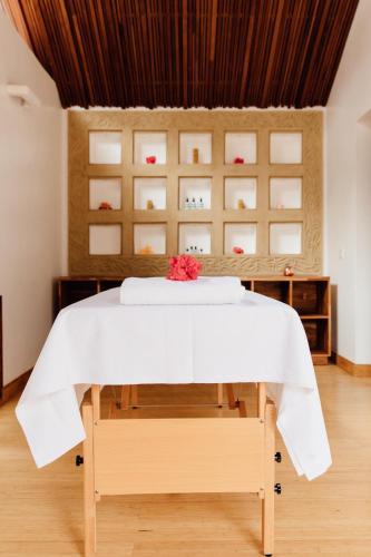 a bedroom with a bed with a white table at Hemingways Retreat Kigali in Kigali