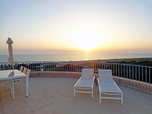a patio with a table and chairs and the ocean at Apartment Suite 48 by Interhome in Tirrenia