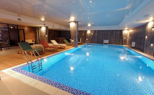 a large swimming pool in a hotel room at Gudauri Redco Block 4/304 in Gudauri