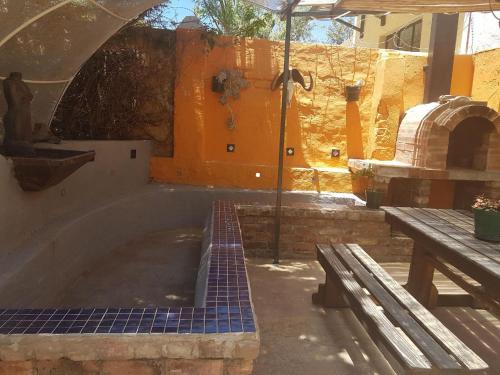 a large plunge pool in a building with a wooden bench at Trackers Inn in Graaff-Reinet