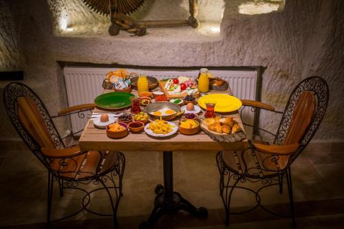 a table with food on it in a room at Agarta Cave Hotel in Goreme