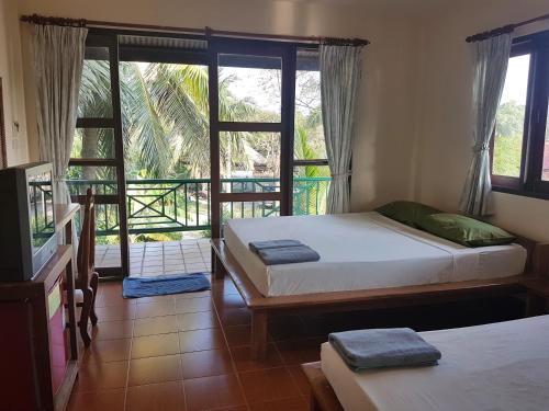 A bed or beds in a room at First Villa Beach Resort