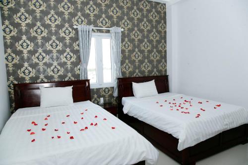 Una cama o camas en una habitación de Hoang Dang Hotel