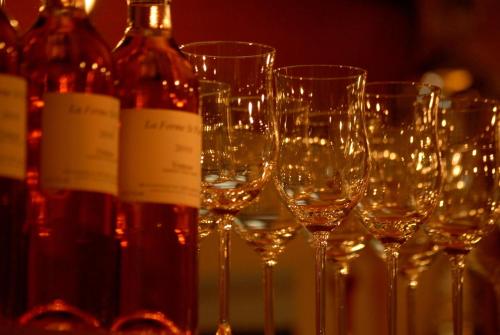 a group of wine glasses sitting on a table with wine bottles at Hotel Wolf in Prague