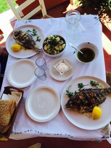 a white table with plates of food on it at Avgerinos Village in Agiassos