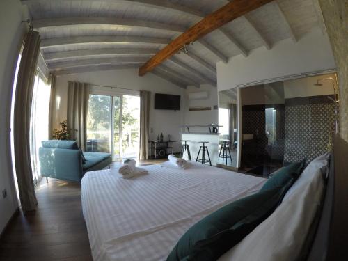 a bedroom with a large bed in a room at Rokamare Beach Resort in Liapades