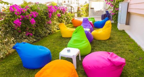 a group of colorful bean bags sitting on the grass at Fethiye Pension in Fethiye