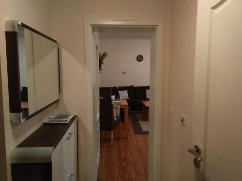 a hallway with a mirror and a living room at Valentina in Baden-Baden