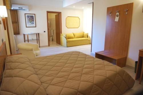 a bedroom with a bed and a living room at Bel Sito Hotel Due Torri in Manocalzati