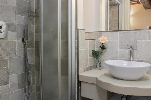 a bathroom with a sink and a shower at L'Antico Cipresso in Poppi