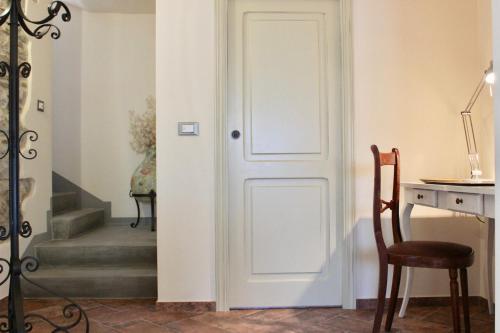 a door in a room with a desk and a chair at L'Antico Cipresso in Poppi