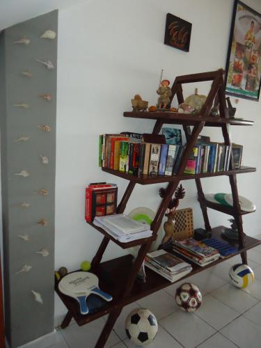 a book shelf with books and a soccer ball at Whitepearl Beach in Hikkaduwa