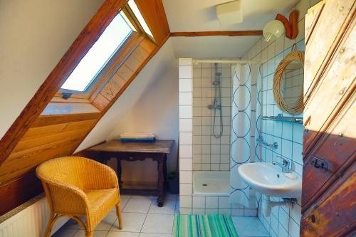a attic bathroom with a sink and a toilet at Dom Przysłupowy Educare -Agroturystyka Slow Food in Świeradów-Zdrój
