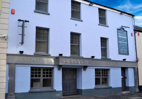 a white building with a sign on the front of it at New Park Hotel in Carmarthen