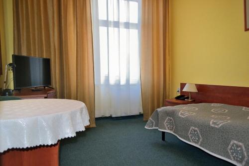 Postel nebo postele na pokoji v ubytování Hotel Kapitan