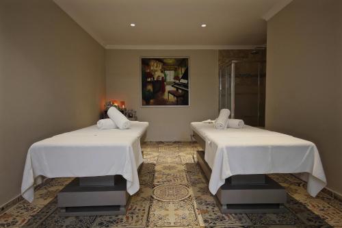 two beds with white sheets in a room at Dalyan Resort - Special Category in Dalyan