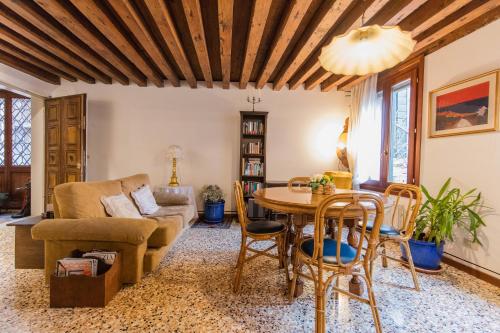 uma sala de estar com uma mesa e um sofá em Venice and Venice Apartments - private rooms in shared apartment em Veneza