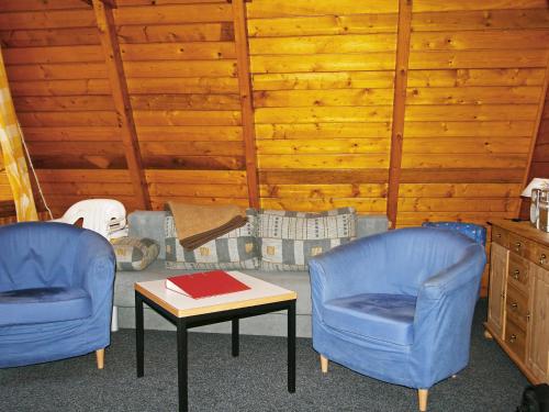 2 blaue Stühle und ein Tisch in einem Zimmer in der Unterkunft Chalet Nepumuk-1 by Interhome in Arendsee