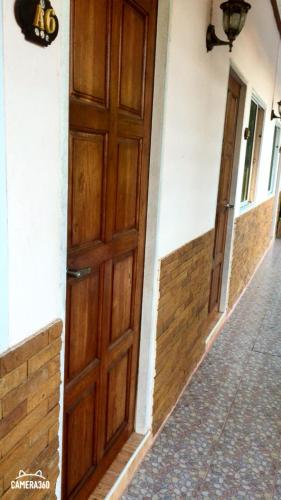 a wooden door on the side of a building at Charlee House in Trang