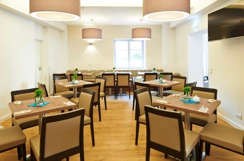 a dining room with wooden tables and chairs at Hotel Elch in Nuremberg