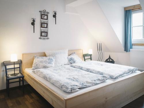 a bedroom with a large bed with white sheets at Rinntaverne in Palfau