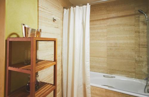 a bathroom with a shower curtain and a tub at Alcam Plaza Cataluña in Barcelona