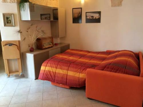a bedroom with a bed and a couch in it at A' Puteja in Ceglie Messapica