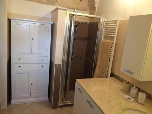 a bathroom with a shower and a white cabinet at A' Puteja in Ceglie Messapica
