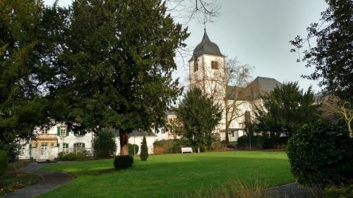 a large white building with a clock tower at Altstadtappartement Königswinter in Königswinter