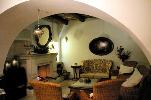 a living room with a couch and a fireplace at San Francesco Resort in Agropoli