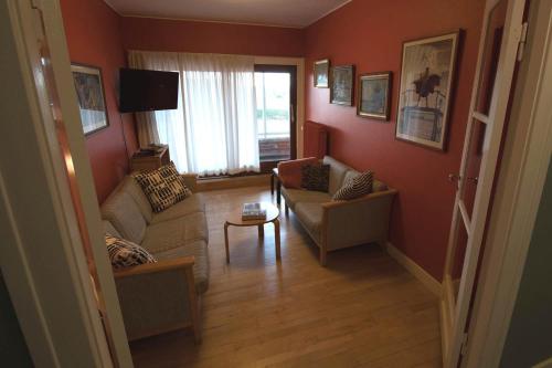 a living room with two couches and a television at Hotel Lolland in Nørreballe
