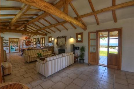 a large living room with a couch and a fireplace at Sa Rezzetta in Golfo Aranci