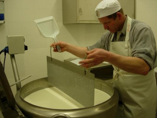 a man in a kitchen preparing a toilet at Kaserhof in Bressanone