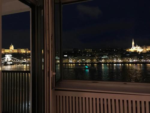 a view of a city at night from a window at Apartment Castle View in Budapest