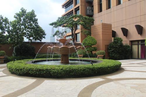 a fountain in a courtyard in front of a building at Best Apartment at Times Square in Kuala Lumpur