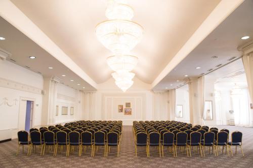a room with a row of chairs and a chandelier at Tsarsko Selo Spa Hotel in Sofia