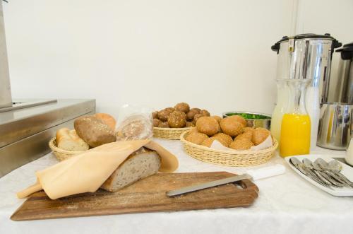 a table with baskets of bread and baskets of food at Regina Goren Hotel in Ashqelon
