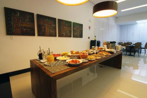 a buffet of food on a table in a room at Tupyguá Brasil Hotel in Pedro Leopoldo