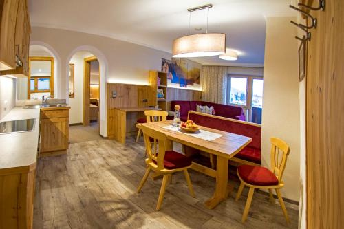 a kitchen and dining room with a table and chairs at Haus Sonnleit in Kössen