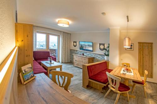 a living room with a couch and a table at Haus Sonnleit in Kössen