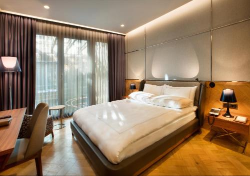 a hotel room with a large bed and a desk at Fer Hotel in Istanbul
