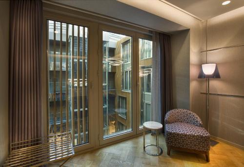 a room with a chair and a large window at Fer Hotel in Istanbul