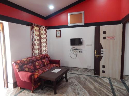 a living room with a couch and a basketball hoop on the wall at Asian Grand Villa in Bolpur