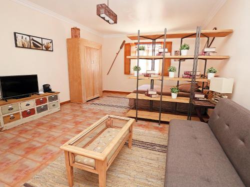 a living room with a couch and a coffee table at Studio Studio Ericeira by Interhome in Ericeira