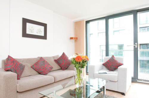 a living room with a couch and a glass table at Cleyro Serviced Apartments - Finzels Reach in Bristol
