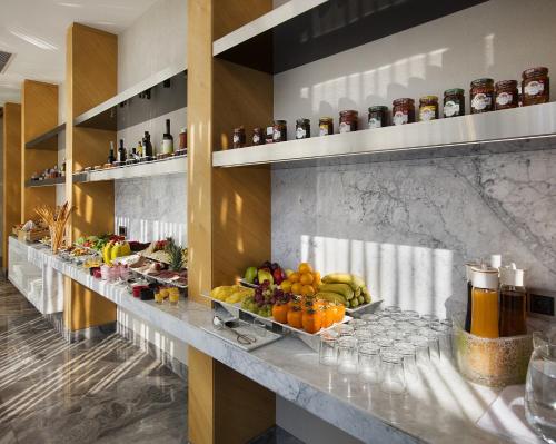 a buffet line with fruits and drinks on it at Fer Hotel in Istanbul